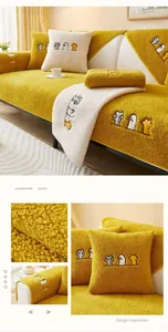 Close-up of thick yellow lamb wool sofa cover with cute rock-paper-scissors embroidery