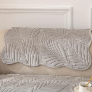 Gray plush velvet sofa cover with embossed leaf pattern and wavy edges for living room