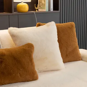 Plush faux fur sofa cushions in beige and caramel displayed in a cozy home setting