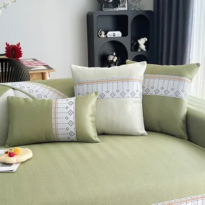 Sage green ice silk sofa mat with herringbone weave and decorative floral cushions