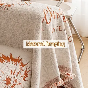Housse de canapé de Noël en chenille avec flocons orange et franges, style nordique