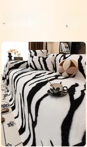 Close-up of soft rabbit fur plush sofa cover with stylish black and white zebra pattern