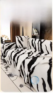 Macro shot of faux rabbit fur sofa throw with black and white zebra pattern texture