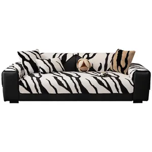 Three-seater sofa with zebra pattern plush cover and decorative pillows on white background