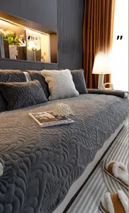 Close-up of thick grey crystal velvet sofa cushion with quilted floral and feather patterns