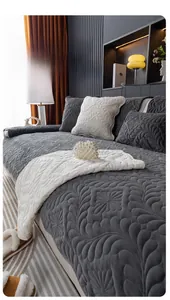 Detailed texture of thick quilted plush sofa cover with elegant floral embossing patterns