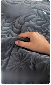 Close-up of thick grey plush sofa cushion showing premium quilted floral texture and softness