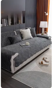 Detail of dark grey plush sofa cover with embossed floral texture on a white leather sofa