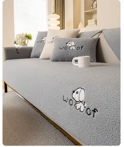 Close-up of gray lamb fleece sofa cushion featuring cute cartoon dog embroidery and soft texture
