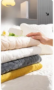 Detail of floral quilted plush sofa cushion showing soft texture in multiple colors
