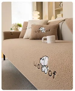 Close-up of thick sherpa sofa cushion with dog embroidery and woof lettering