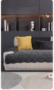 Close-up of gray plush sofa cover with wave quilting and yellow throw pillow detail