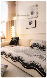 Detailed view of wave-edged chenille sofa cover with black and white geometric pattern