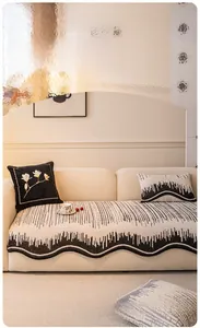 Close-up of black and white wavy edge sofa cushion with abstract vertical stripes