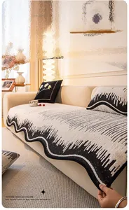 Detail of plush black and white wavy sofa cushion with heating yarn and scalloped edges