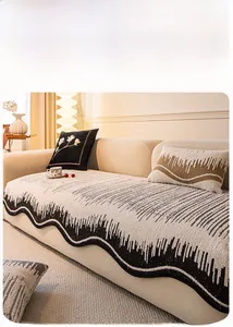 Detail of cream chenille sofa cover with black wavy patterns and matching pillows