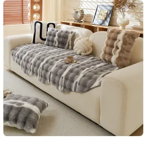 Detail of plush faux rabbit fur sofa cover with wavy texture and soft grey stripes