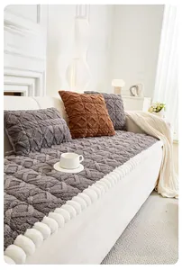 Detail of plush sofa cushion with thick sponge padding and white pom-pom trim design