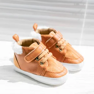 Detailed side view of brown baby winter shoes with soft fleece lining and velcro strap