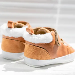 Brown leather baby winter boots with warm plush lining and velcro closure
