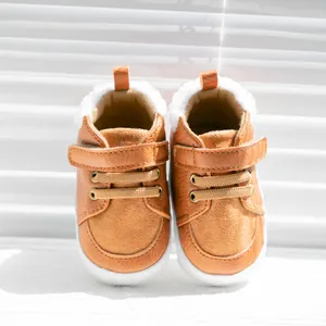Front view of baby winter walking shoes in brown faux leather with warm white plush lining