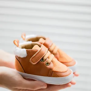 Detail of warm brown baby leather walking shoes with soft wool lining and velcro strap