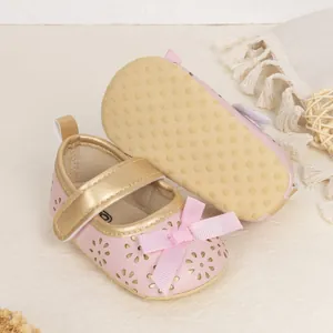 Detail view of baby girl princess shoes with floral cutouts and non-slip soft soles