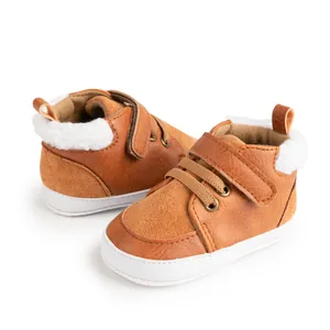 Detail view of baby winter boots in tan suede with thick white faux fur lining and velcro