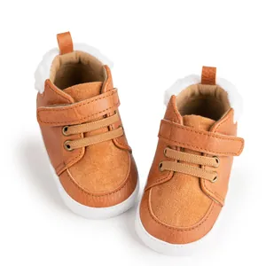 Macro view of baby winter walking shoes with warm fleece lining and velcro closure in brown