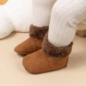 Close-up of brown baby boots with faux fur lining and soft suede texture for winter