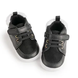 Detailed close-up of winter baby walking shoes with warm fleece lining and velcro straps