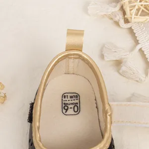 Detail view of baby walking shoe size 18 for 0-6 months with soft PU trim and canvas lining