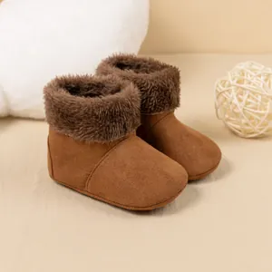 Close-up of baby winter boots in brown faux suede with thick warm faux fur lining