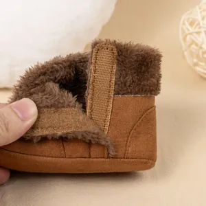 Brown fleece-lined baby winter boots with velcro closure and soft warm faux suede material