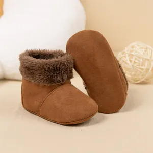 Detail of warm baby snow boots featuring caramel faux suede and soft faux fur trim