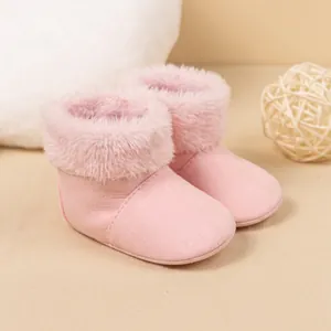 Detail of pink baby snow boots with soft faux suede and warm plush lining for winter