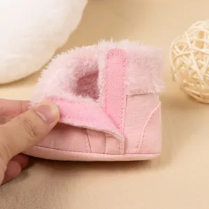 Detail of pink baby winter boot showing soft faux fur lining and Velcro strap closure
