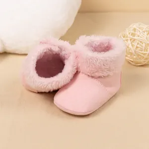 Detailed view of pink faux suede baby boots with warm plush lining and soft sole