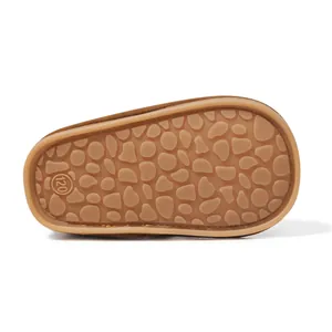 Macro detail of anti-slip rubber sole with pebble texture and size 120 on baby boots