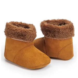 Detail of warm brown baby snow boots with soft soles and plush faux fur lining texture