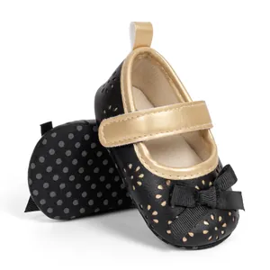 Detail of baby Mary Jane shoes with gold trim, laser-cut patterns, and anti-slip soft soles
