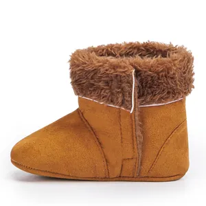 Detail of warm brown baby winter boots featuring soft faux suede and thick plush fur trim