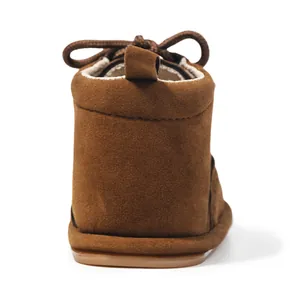 Detail of brown baby boots with non-slip rubber soles and warm fleece lining
