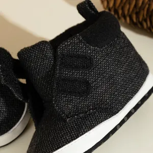 Infant soft-sole high-top baby shoes in dark grey textured fabric with velcro straps