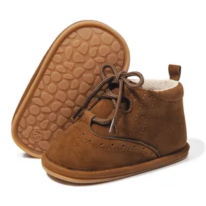 Detail of dark brown baby boots showing anti-slip rubber sole and breathable mesh lining