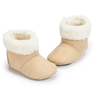 Detail showing the warm plush lining and soft faux shearling trim on baby boots