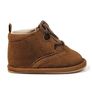Brown faux leather baby boots with non-slip soles and brogue detailing for infants