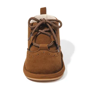 Detailed view of brown baby boots with retro brogue carving and durable non-slip soles