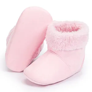 Detail of pink baby boots with soft soles and warm faux fur lining for infants