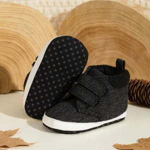 Detail of high-top baby walking shoes with dual hook and loop straps and non-slip soles